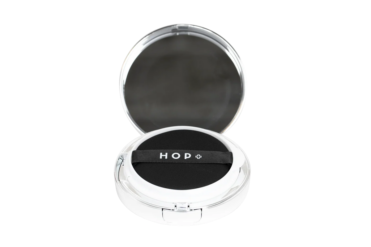 Compact mirror with 'HOP' branding on a white background