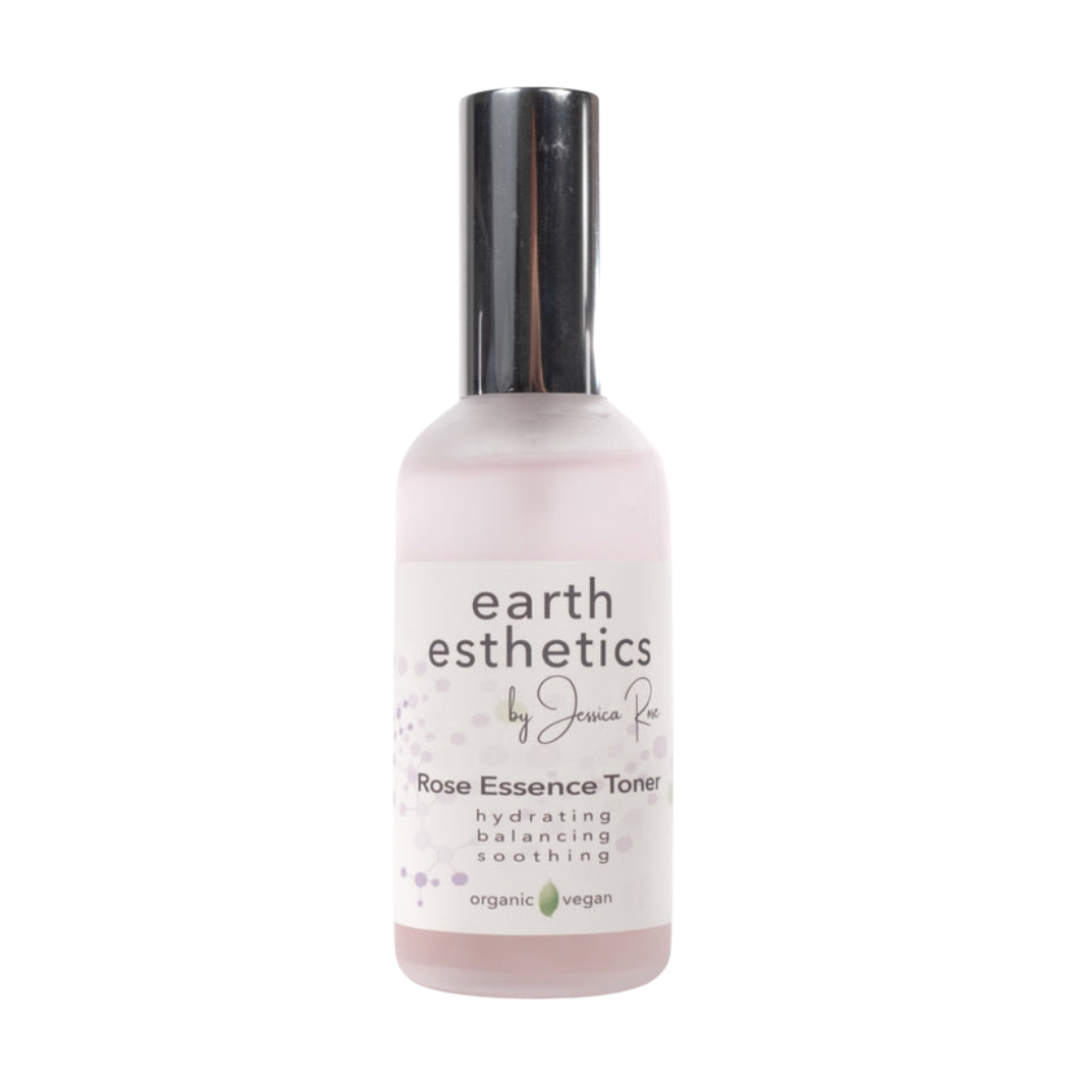 A bottle of Rose Essence Hydrating Toner by Earth Esthetics, with a white label and rose imagery, indicating it is a skincare product with a rose essence.